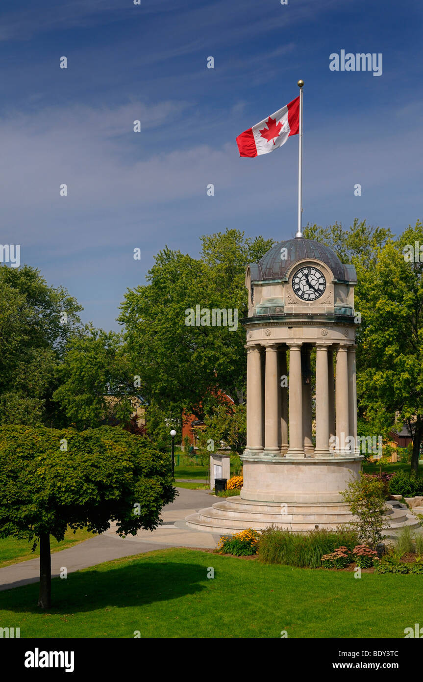 Old City Hall Clock Tower in Victoria Park Kitchener Ontario with Canadian flag Stock Photo