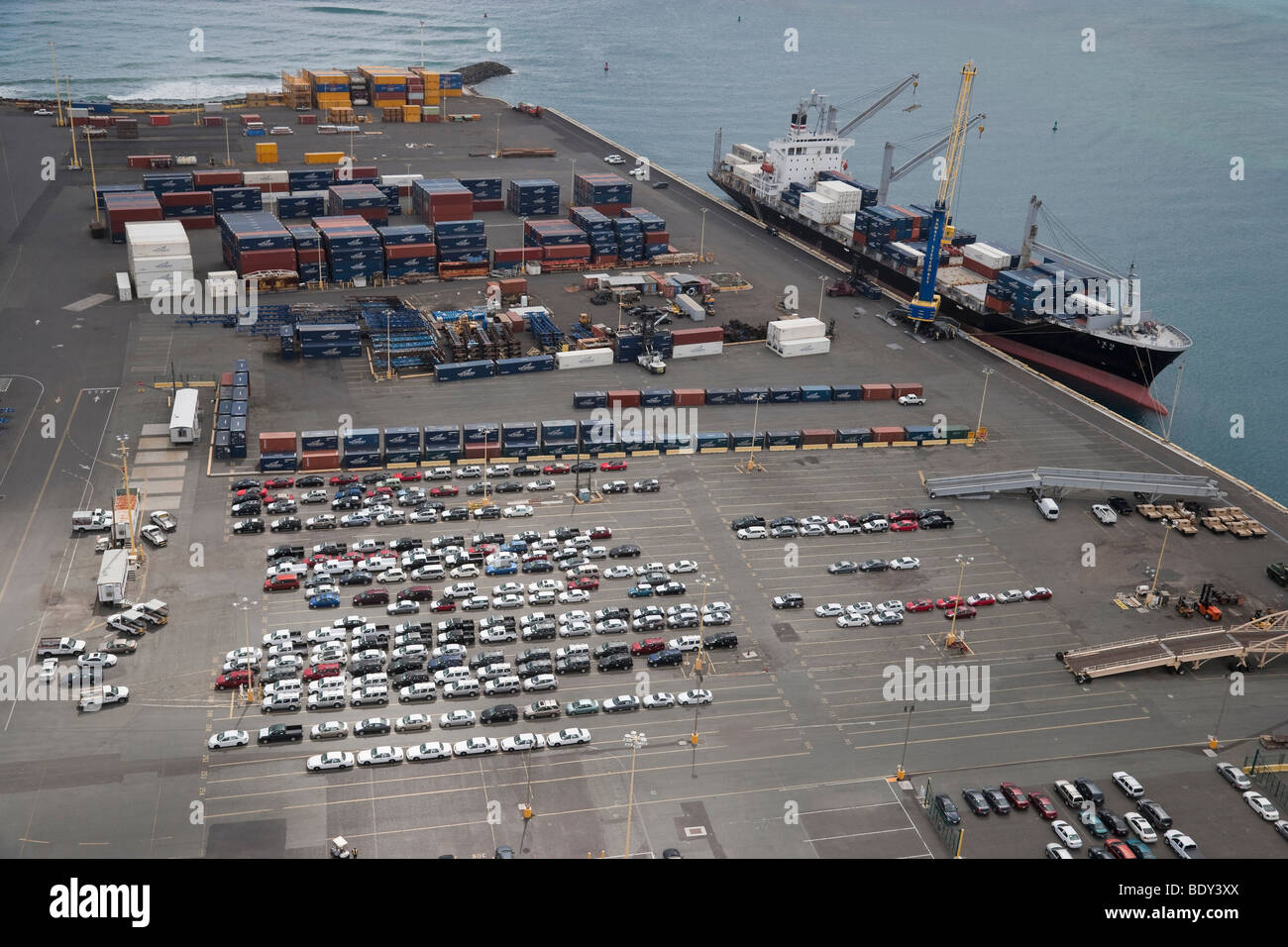 Aerial view of autos imported and containerized cargo container and cargo ship on Sand Island, Honolulu, Hawaii. Stock Photo