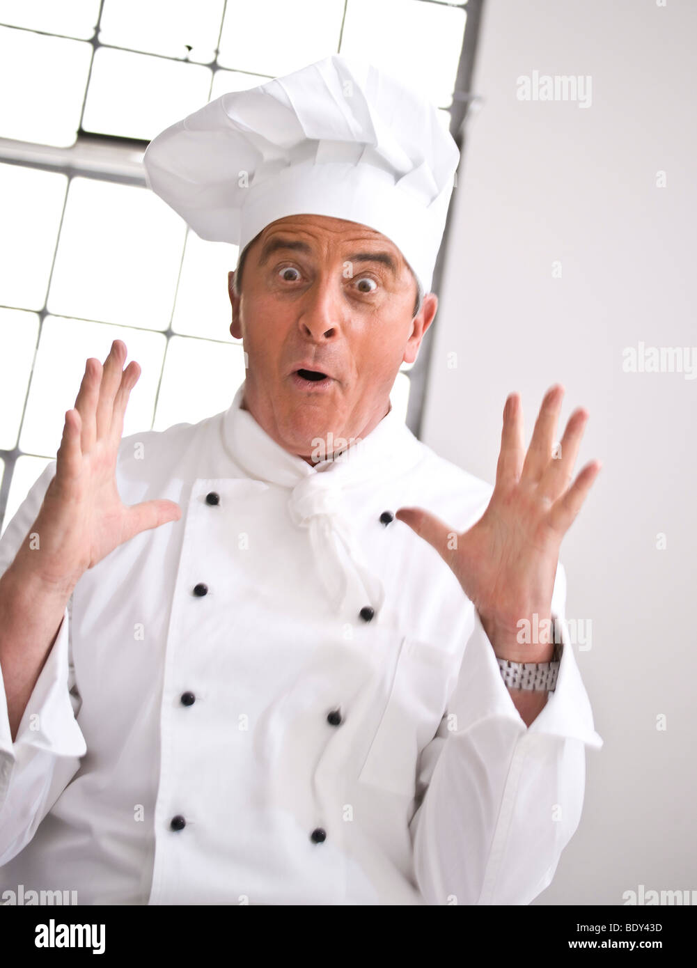 Surprised looking chef wearing a chef's hat Stock Photo Alamy