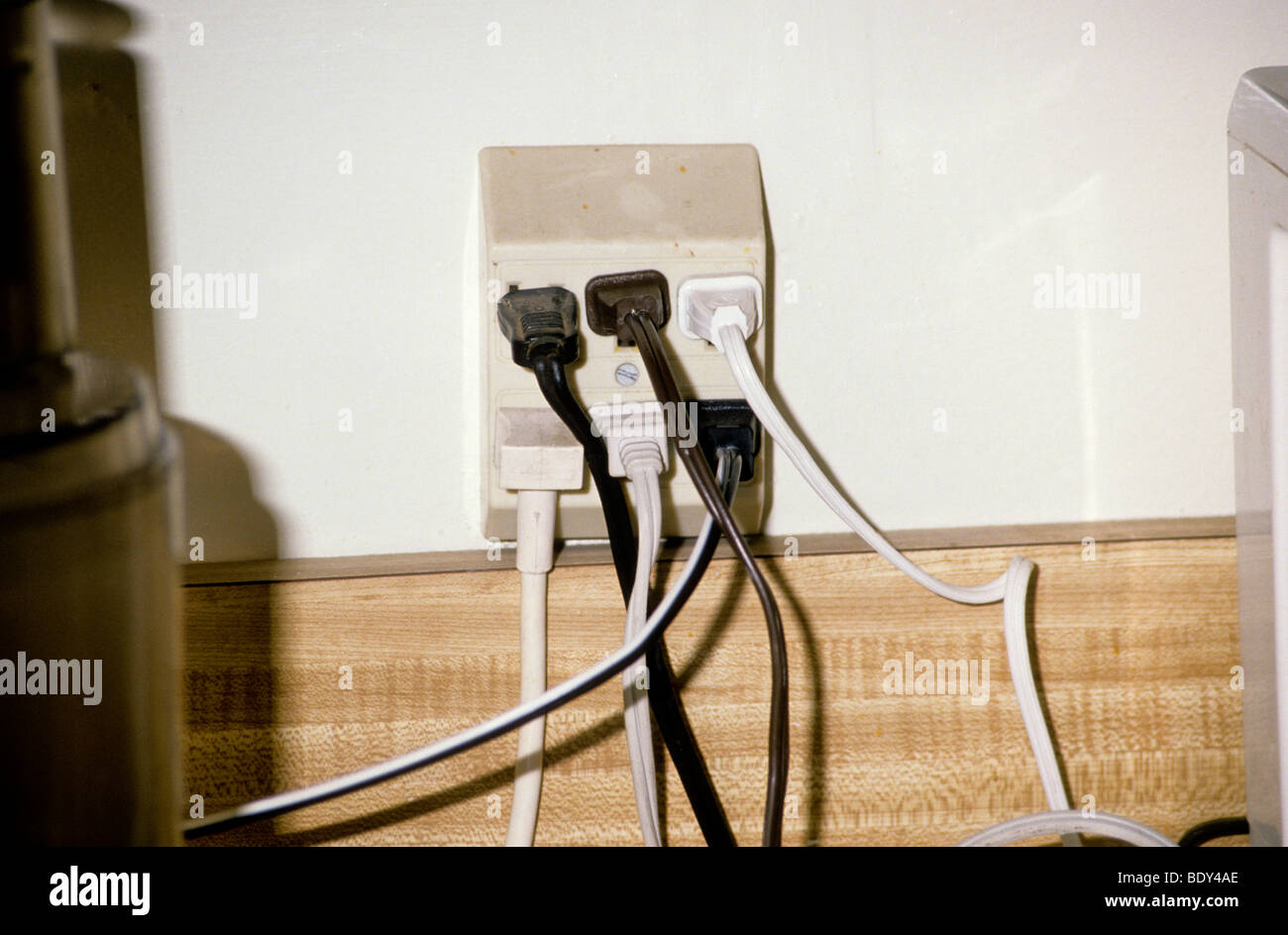 overloaded wall electrical outlet fire hazard danger threat Stock Photo