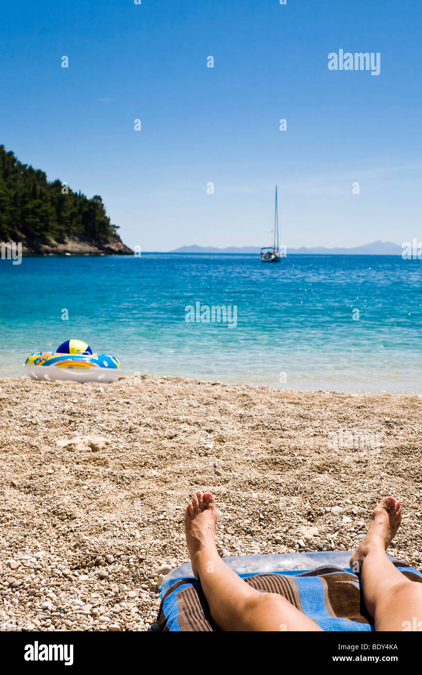 Woman relaxing on the beach, Korcula island, Dubrovnik Neretva, Dalmatia, Croatia, Europe Stock Photo