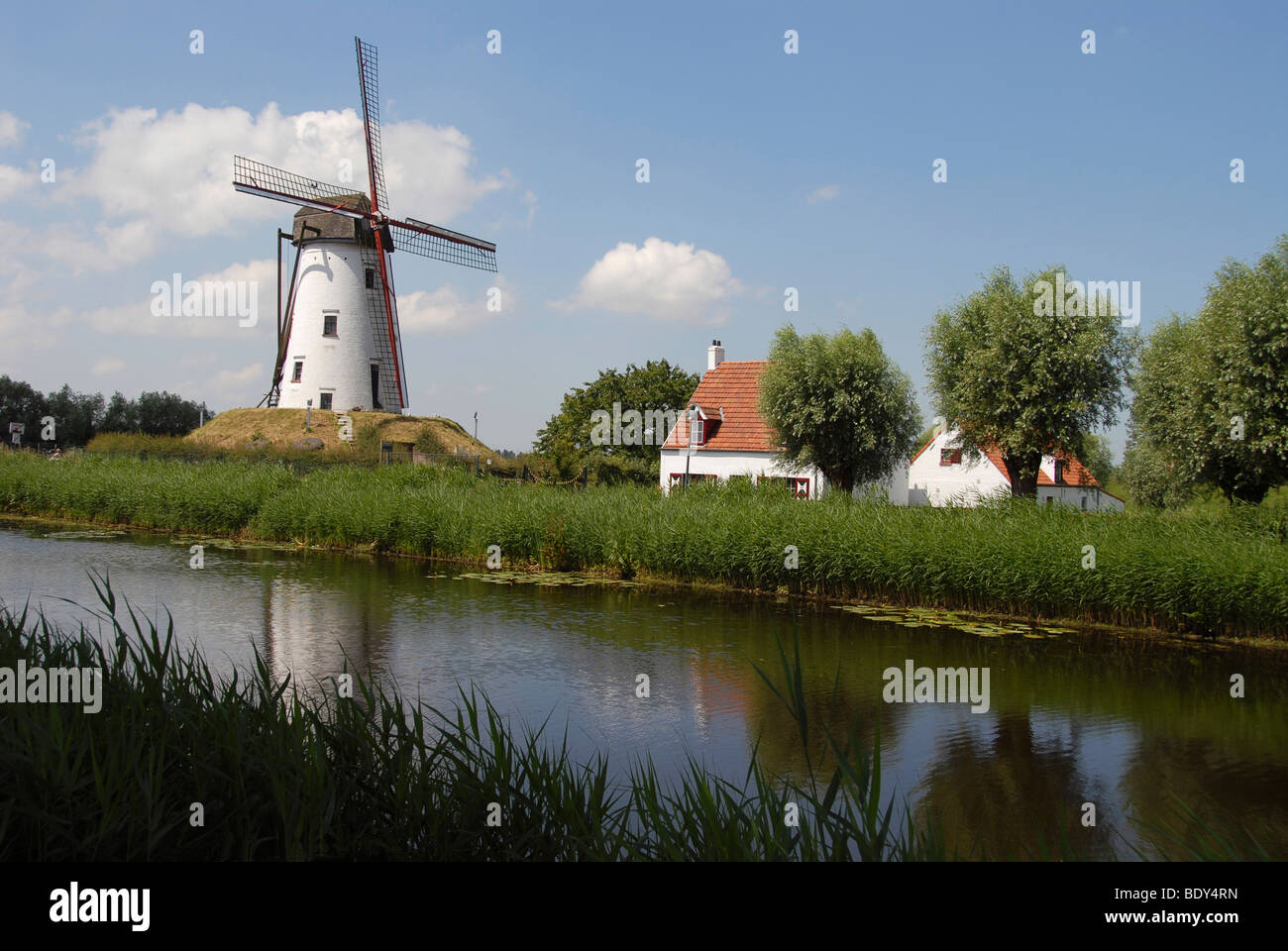 Traditional Windmill by canal in Damme, near Bruges, Belgium. Stock Photo