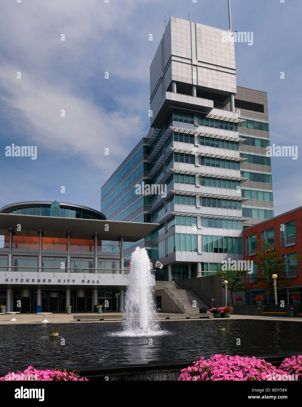 Flowers along fountain pool at modern architecture of Kitchener City