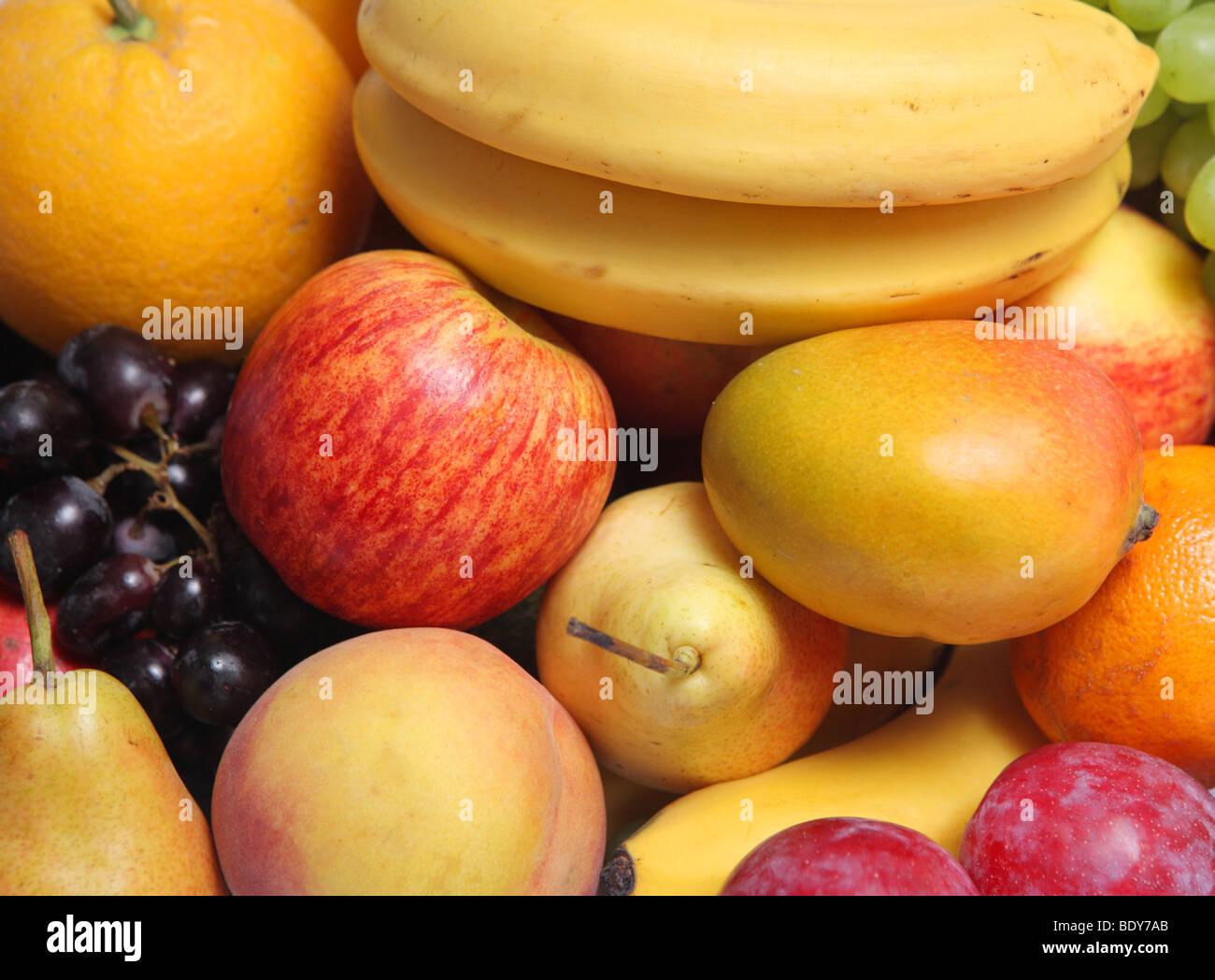 An Assortment Of Fresh Fruits Including Apple Mango Banana Grapes