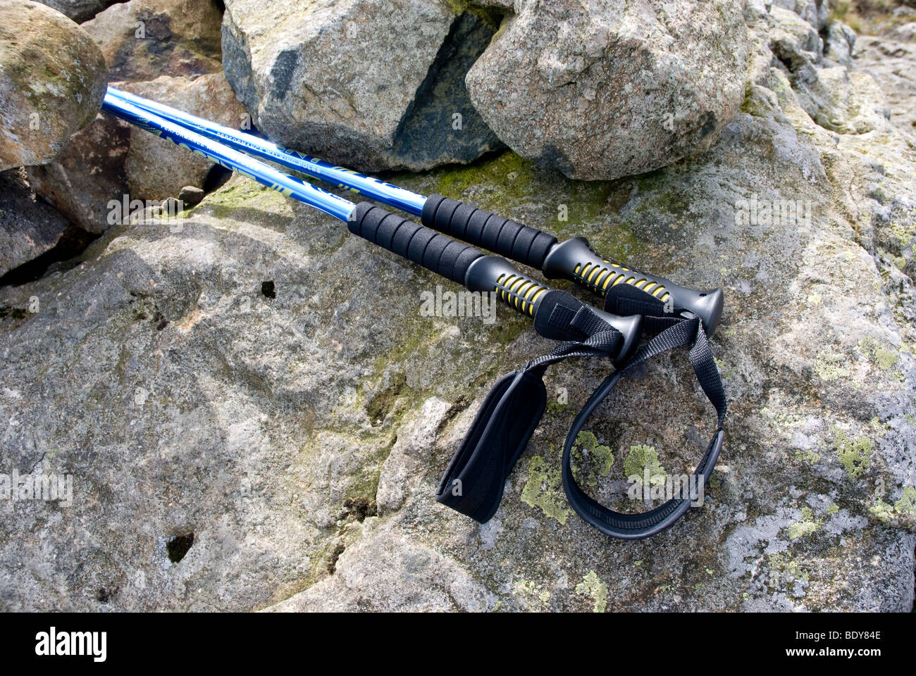 A pair of walking poles resting on some rocks on a Cumbrian fell Stock Photo