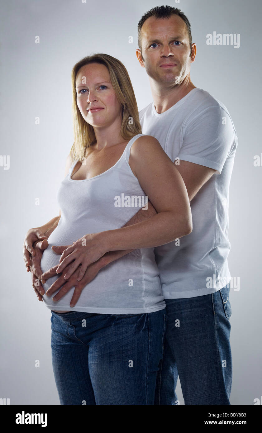man hugging pregnant woman Stock Photo
