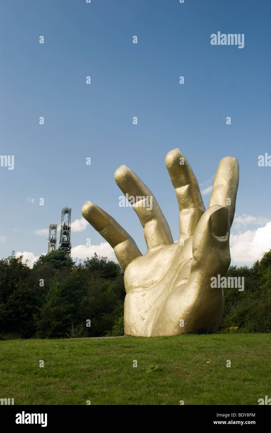 Golden Hand with Clipstone Colliery Headstocks in the Background, Vicar Water Country Park, Clipstone,  Nottinghamshire, UK. Stock Photo