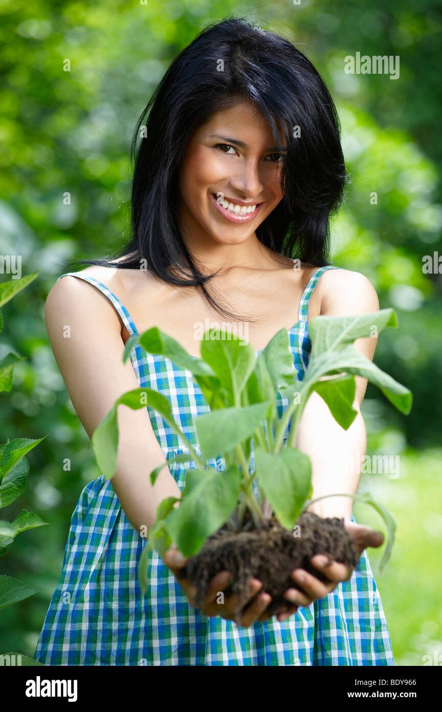 Woman holding a flower pot Stock Photo - Alamy