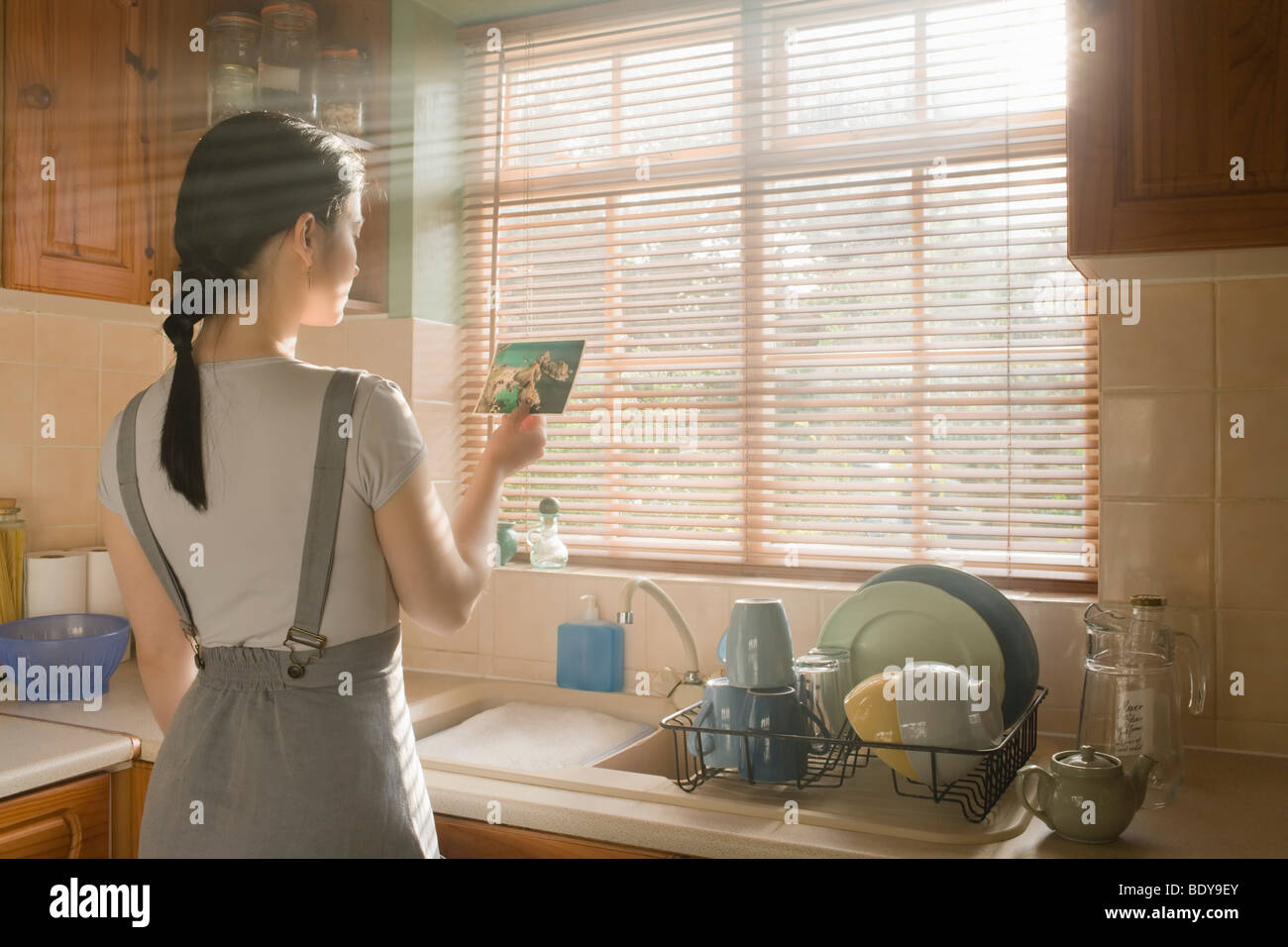 Woman reading post card Stock Photo - Alamy