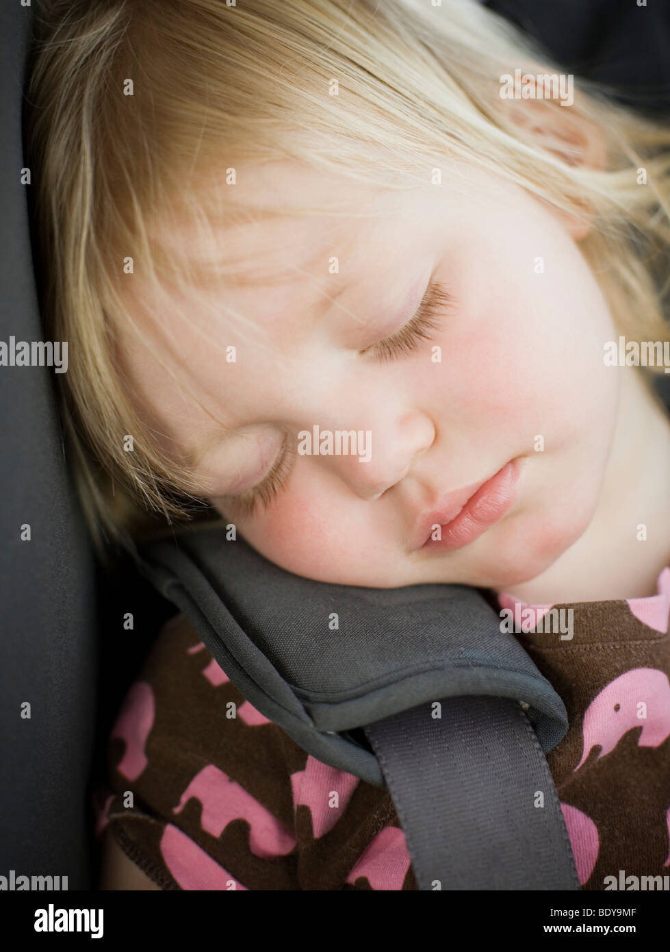 Young child sleeping safely in a car seat Stock Photo Alamy