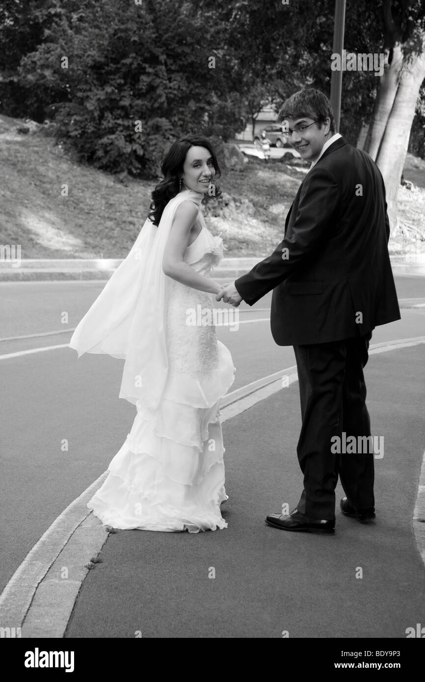 Happy walking newlyweds Stock Photo