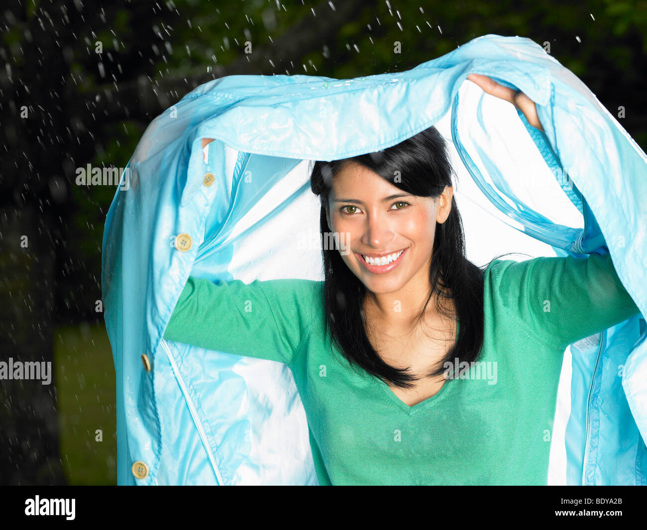 Woman with jacket over her head, rain Stock Photo - Alamy