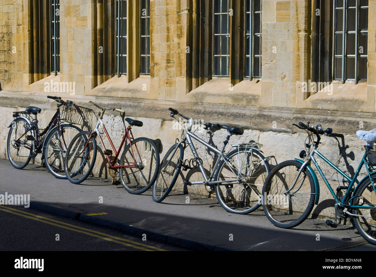 Bicycles parked against the wall of Jesus College, University of Oxford, England Stock Photo