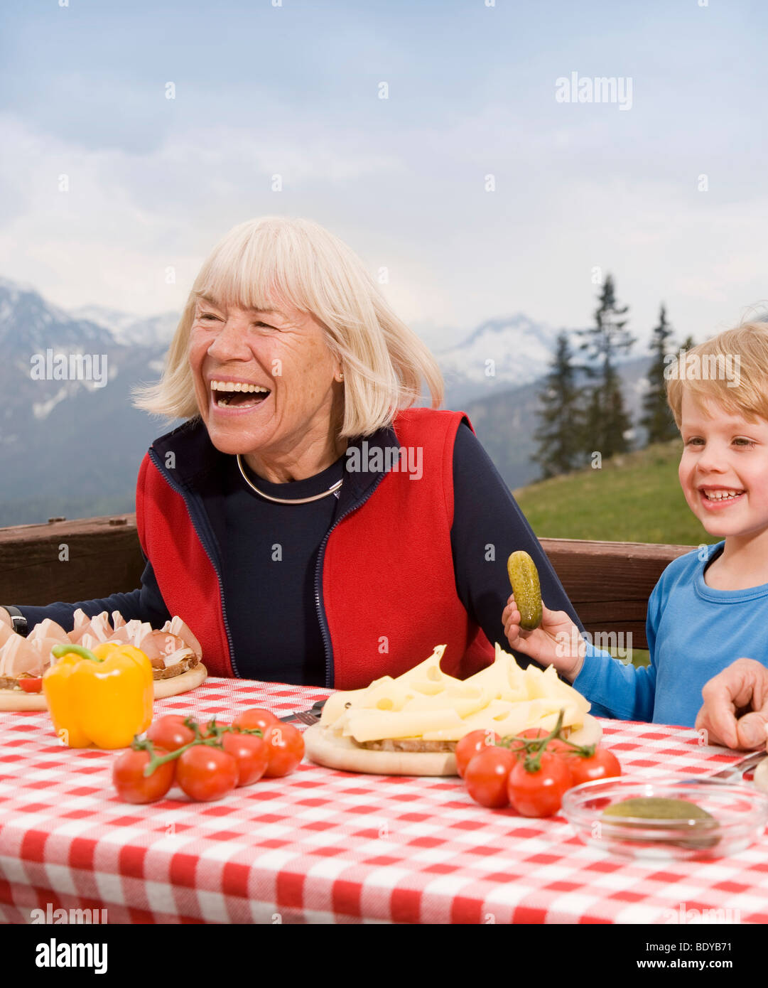 grandmother, grandson eating in mountain Stock Photo
