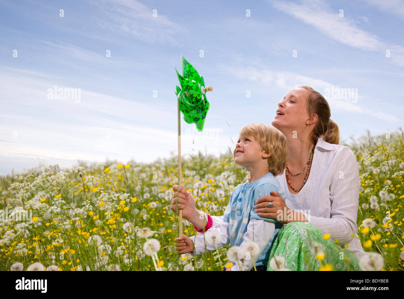 mother and son with green toy windmill Stock Photo - Alamy