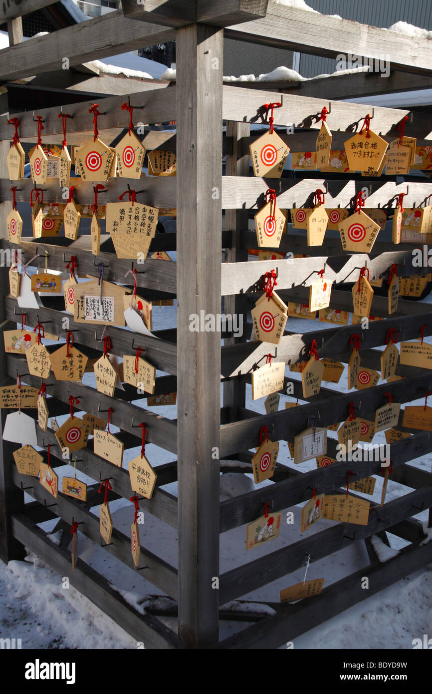 Ema. Pentagon-shaped wishing plates in a Japanese shinto shrine. Sapporo Japan. Stock Photo