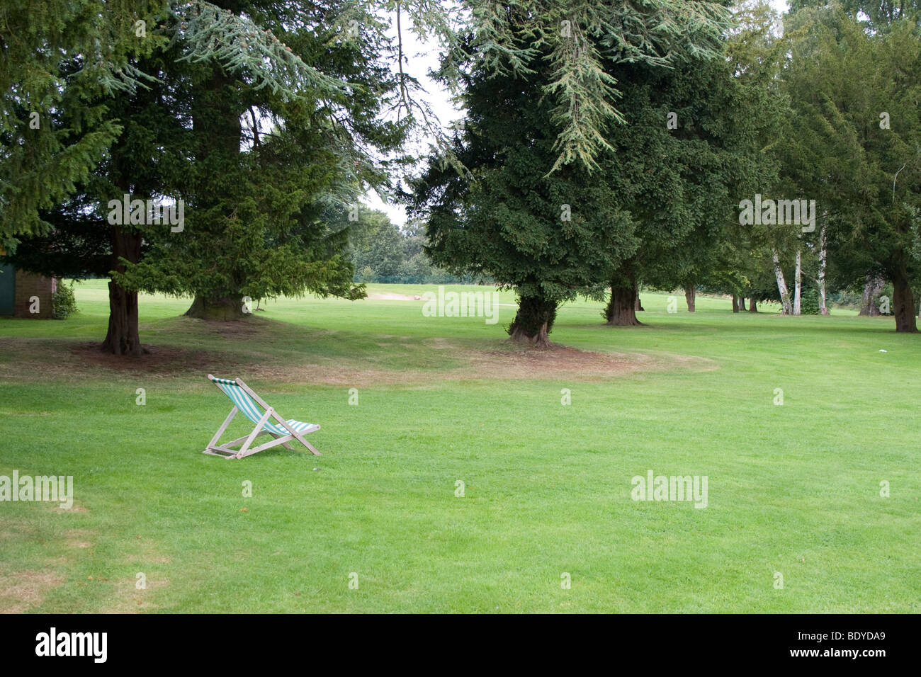 An empty deck chair in the park Stock Photo - Alamy