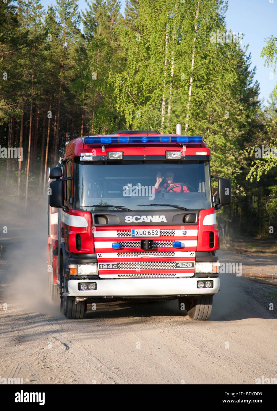 Finnish fire engine driving on a dirt road at countryside , Finland Stock Photo