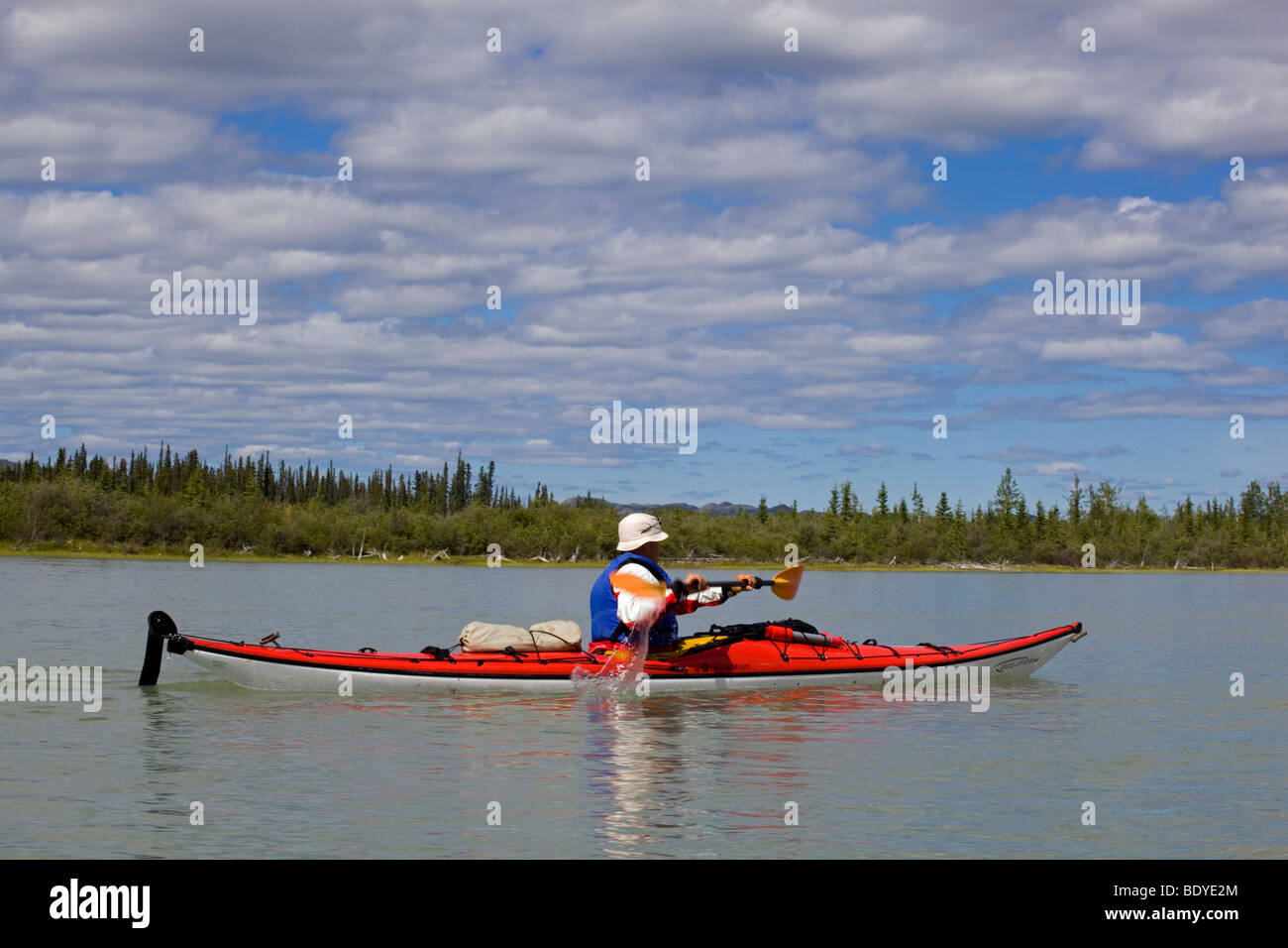 Man paddling a sea kayak on Yukon River near Lake Laberge, Yukon