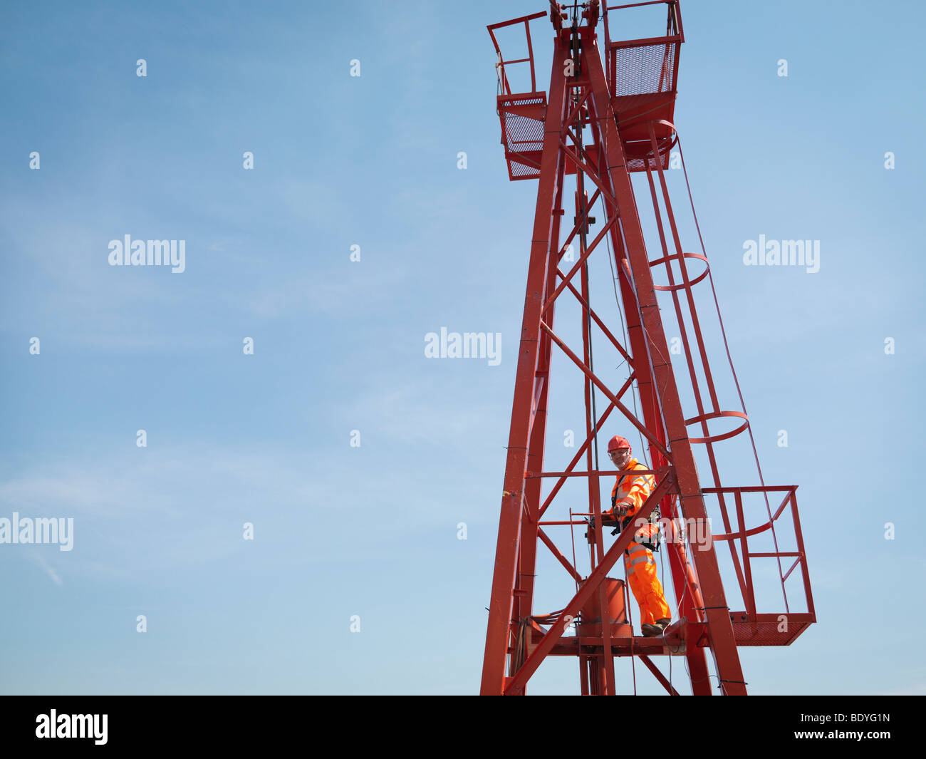 Crane Worker High Up On Crane Stock Photo
