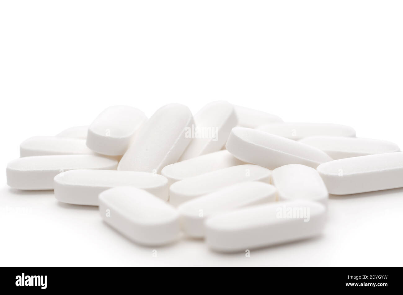 Horizontal shallow focus white pills on white Stock Photo