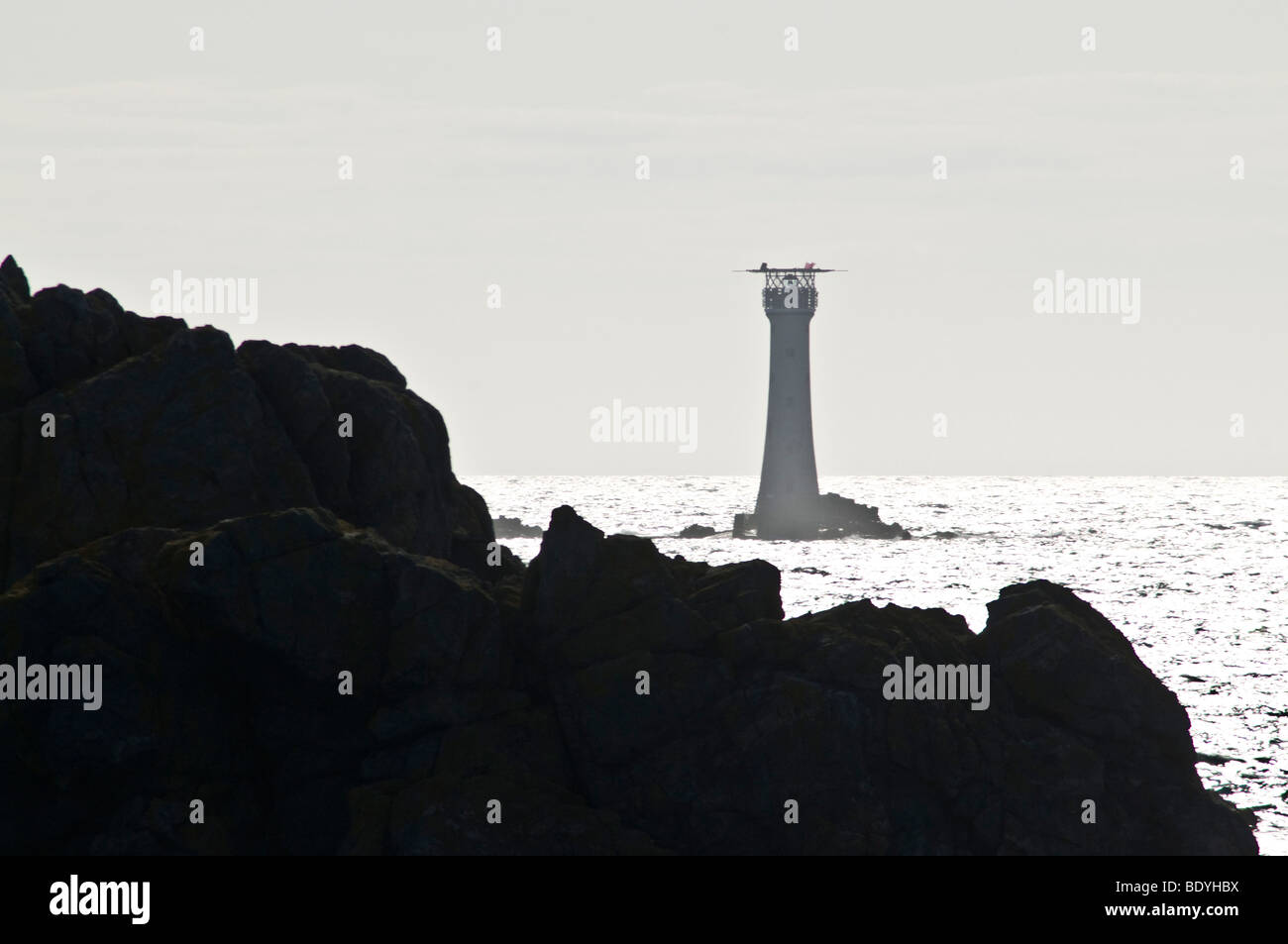 dh Les Hanois Lighthouse TORTEVAL GUERNSEY Lighthouse beacon rocky Les Pezeries shore coast sea rough rocks headland coastline lighthouses Stock Photo