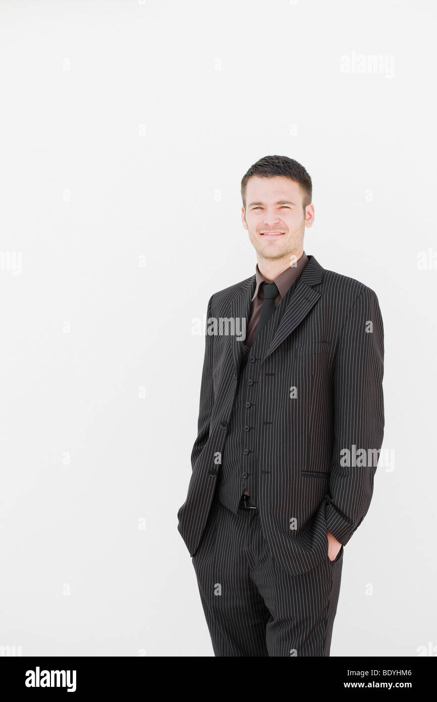 man standing in front of white wall Stock Photo - Alamy
