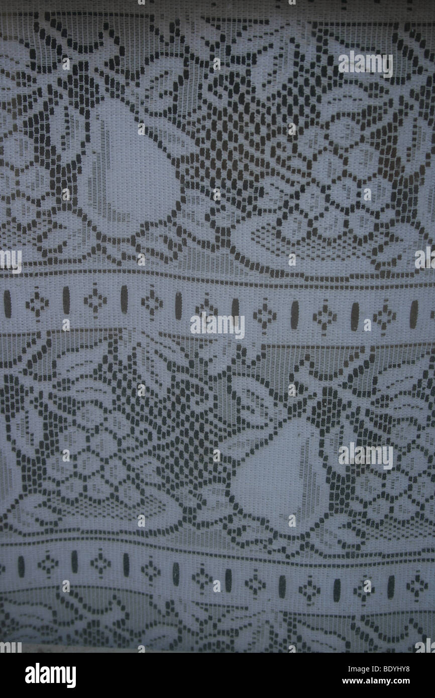 Typical old fashioned French lace curtain Stock Photo
