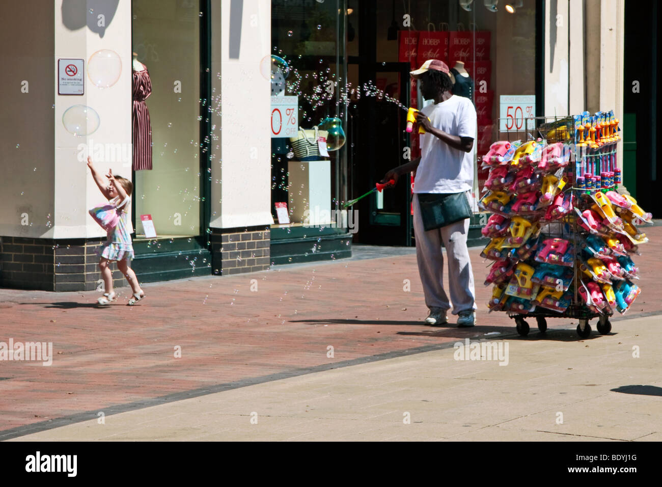 Man generating lots of bubbles in the shopping centre at Royal Tunbridge Wells Stock Photo