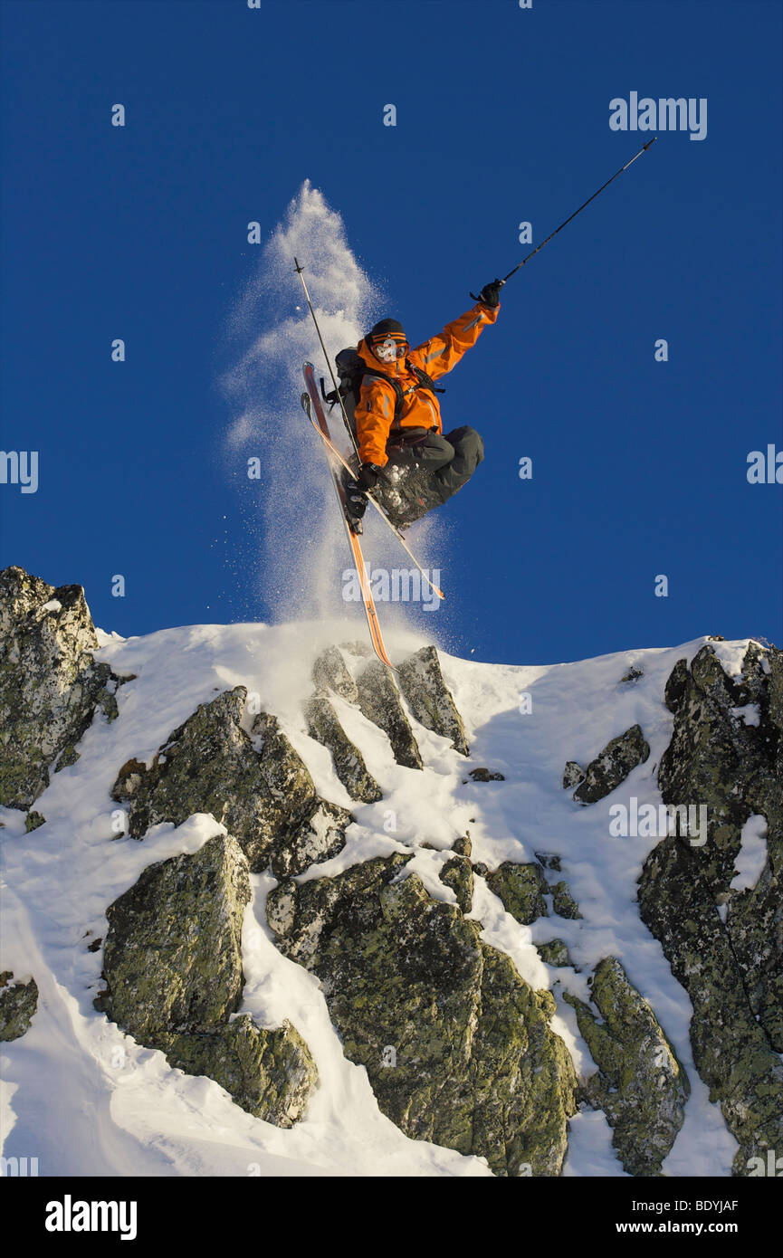 Skier jumping off rocks Stock Photo - Alamy