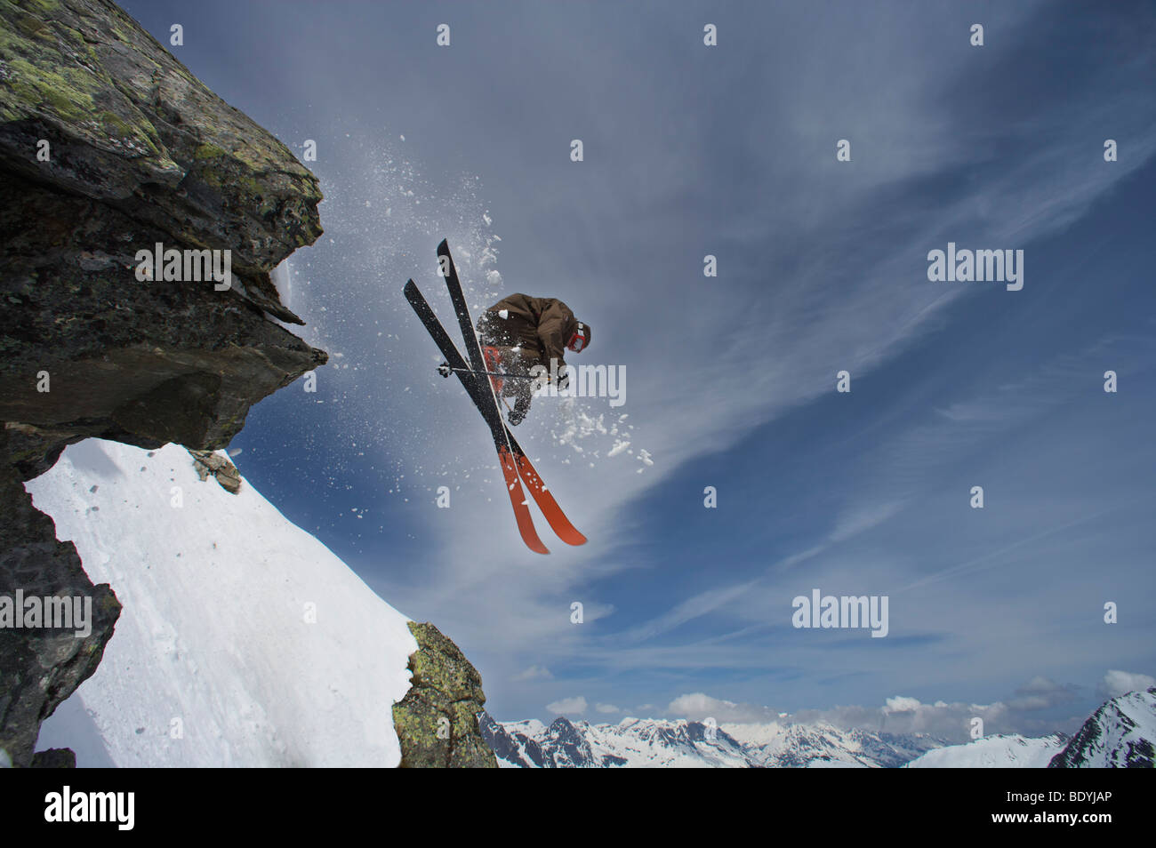 Skier jumping off a rock Stock Photo - Alamy