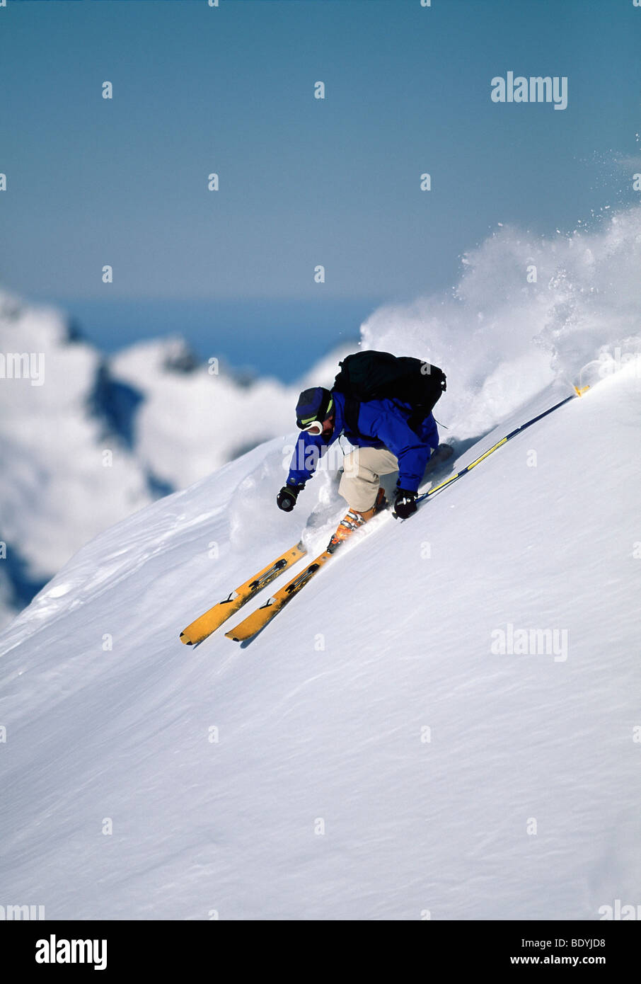 Skier turning down a snow slope Stock Photo