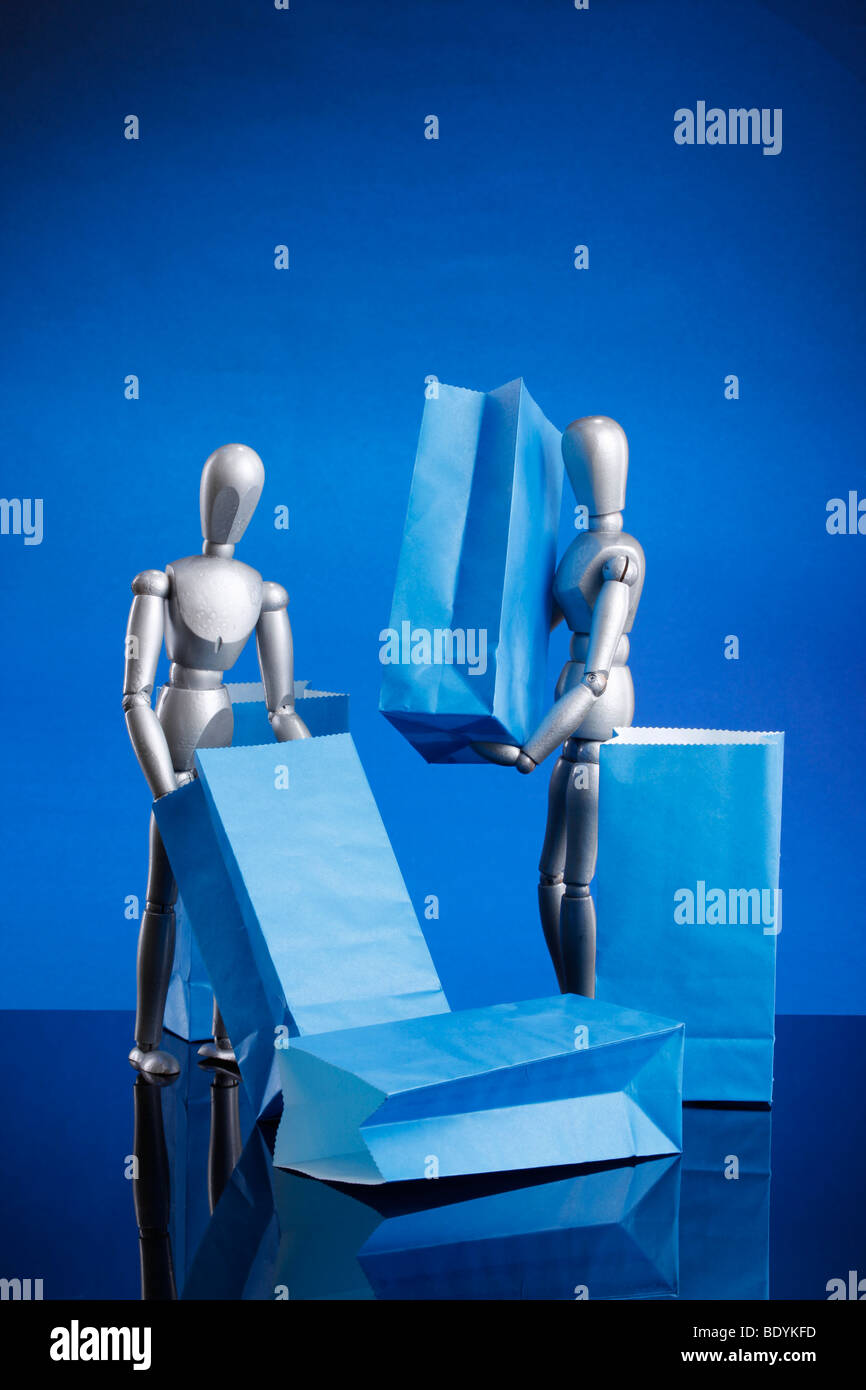Silver dummies carrying gift bags Stock Photo