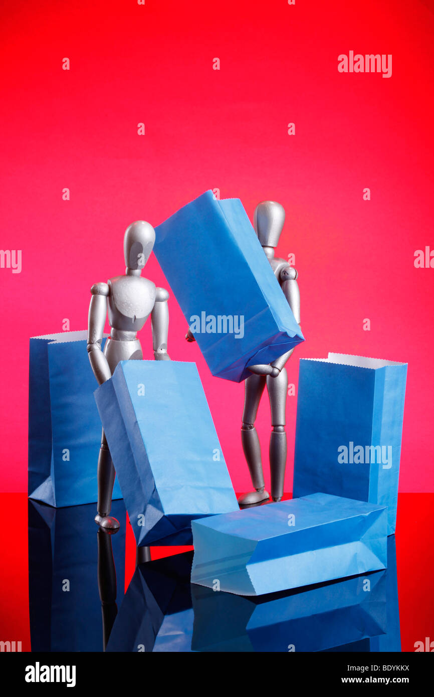 Silver dummies carrying gift bags Stock Photo