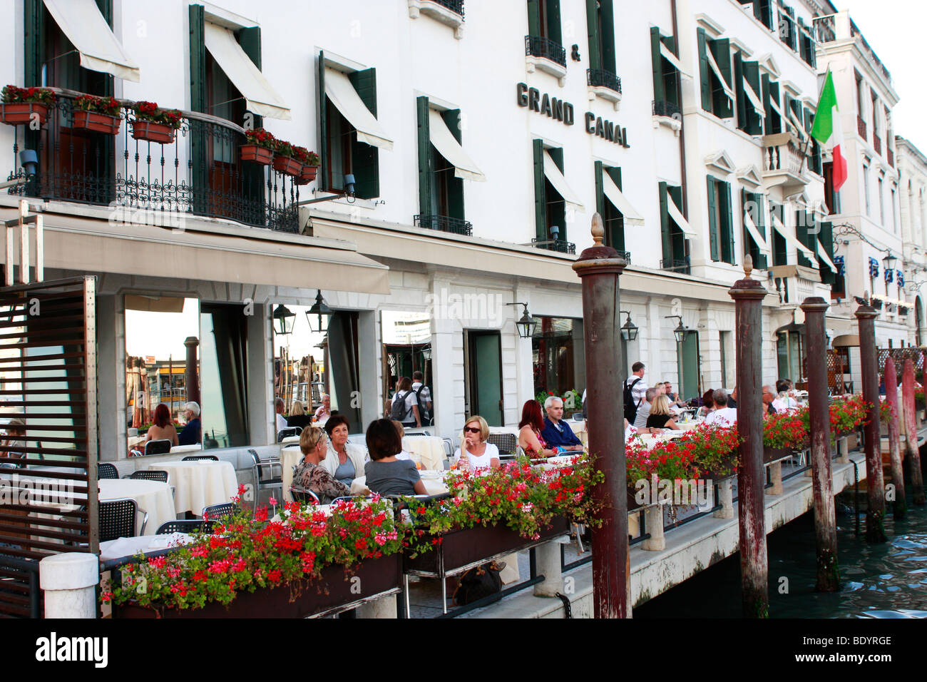 The 'canal side' terrace of the Grand Canal Hotel , Venice,Italy,is a popular place to relax and watch the world go by Stock Photo