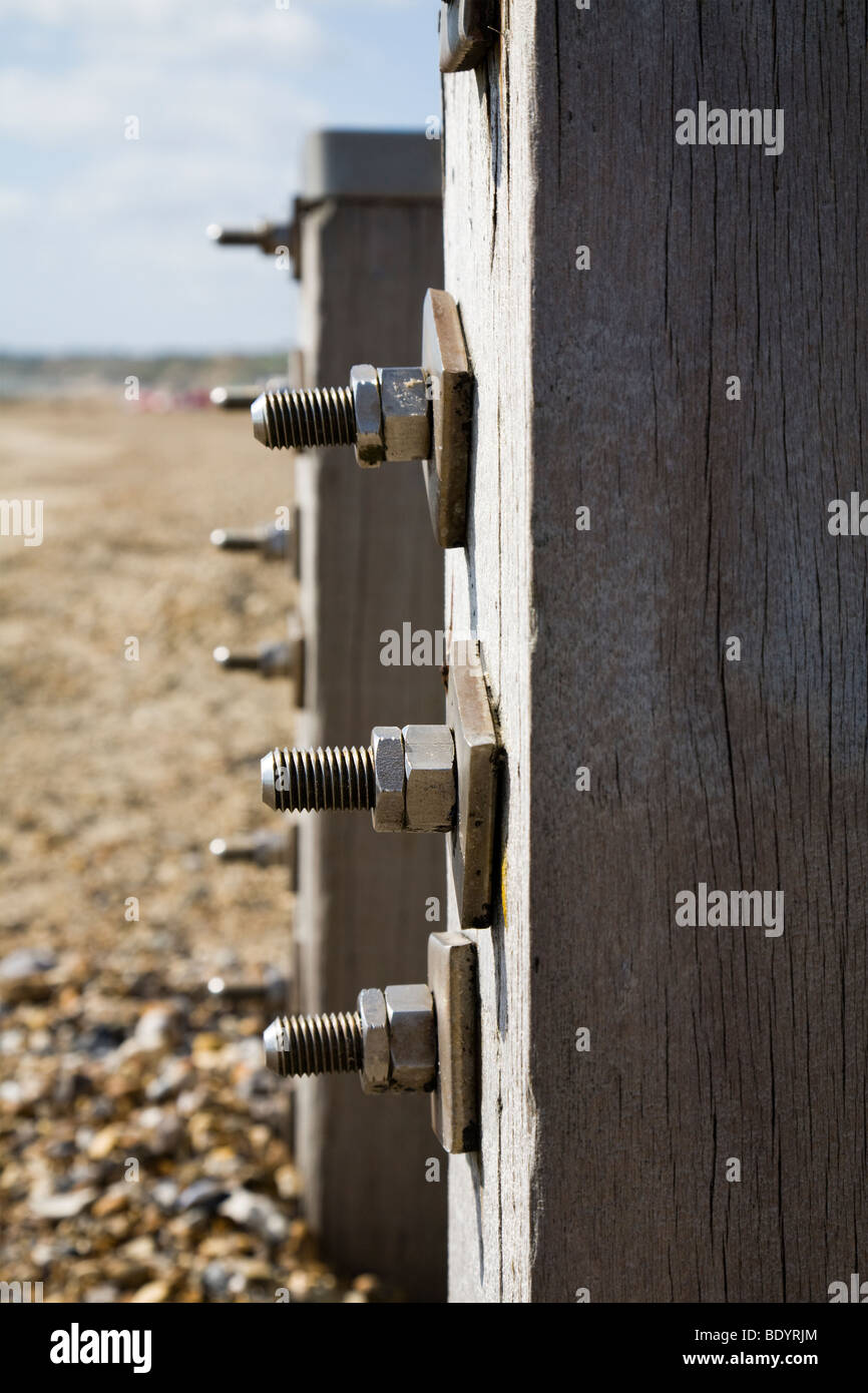 Nuts and bolts on wooden sea defenses, groyne . A beach in Dorset. UK. Stock Photo