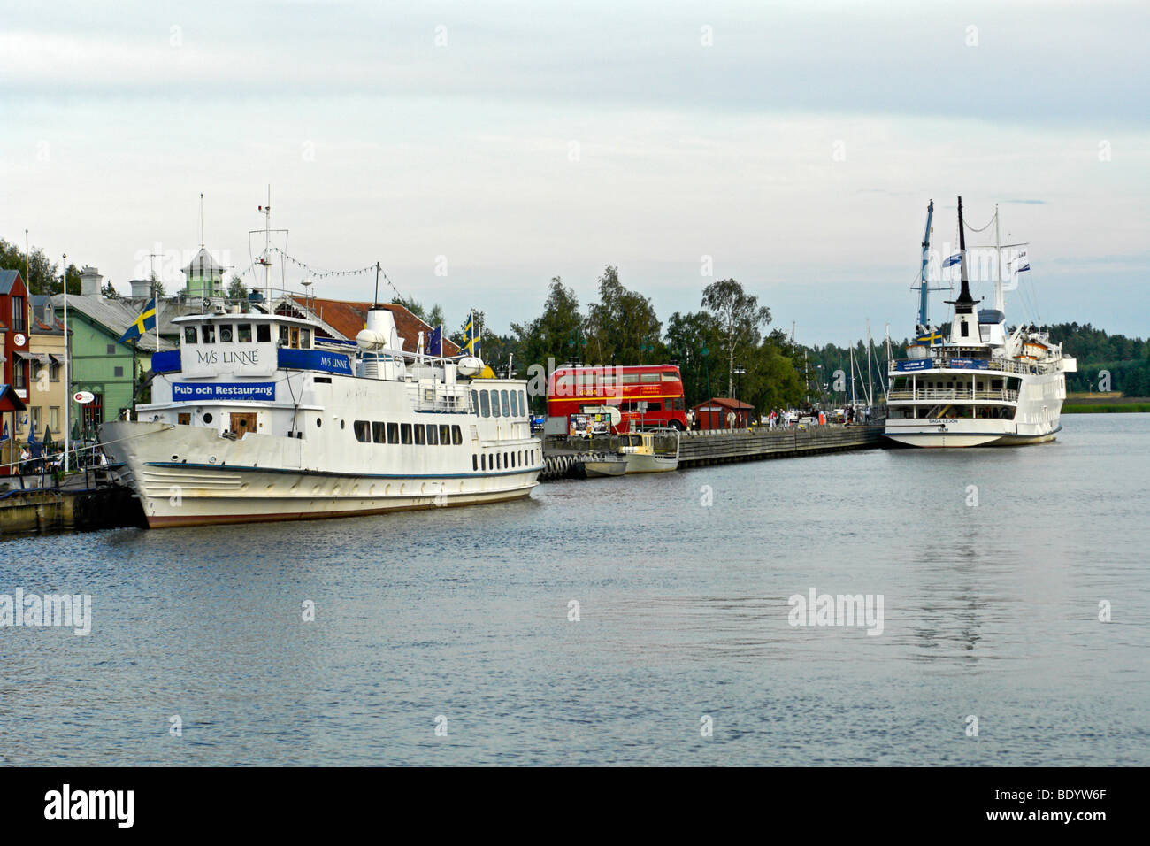 The harbour in Nykoping Sweden, showing archipelago excursion ship M.S. Linne with the Saga Lejon in the middle distance Stock Photo