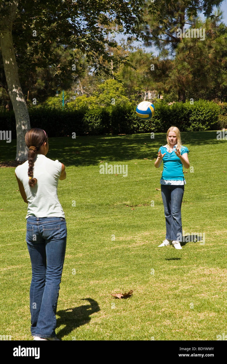Two Junior high girls 11-14 year old olds toss ball to each other. MR  © Myrleen Pearson Stock Photo