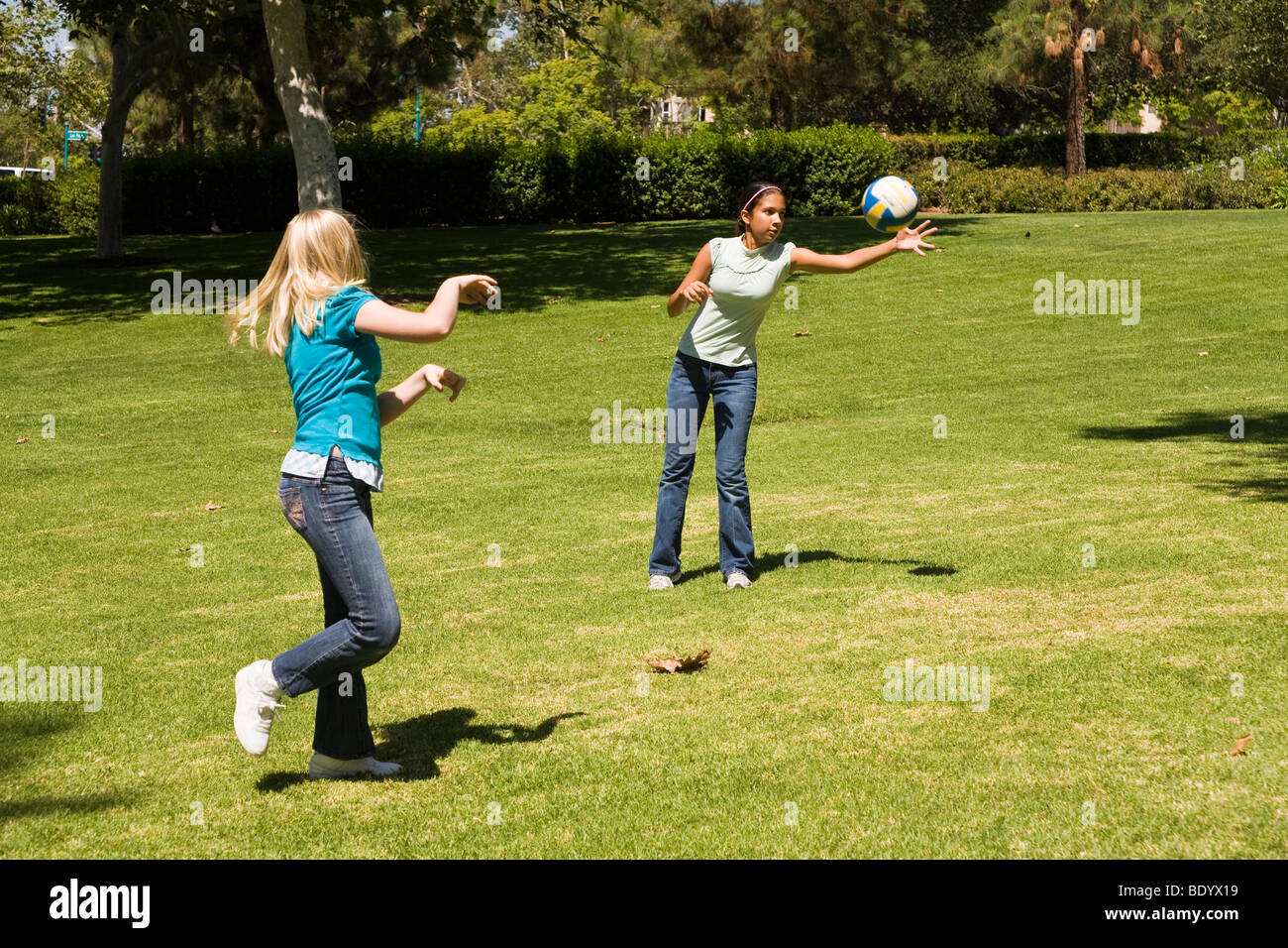 Two teen girls hang hanging out together Junior high girls toss ball to each other. 11-13 year old olds MR  © Myrleen Pearson Stock Photo