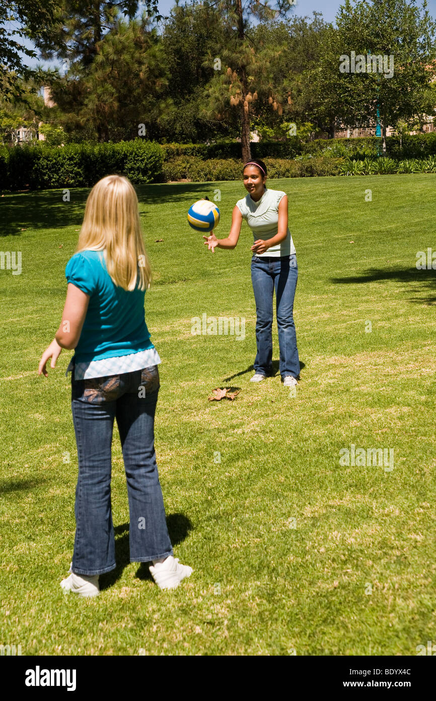 Two teen  girls hang hanging out together Junior high girls toss ball to each other. 11-13 year old olds MR  © Myrleen Pearson Stock Photo