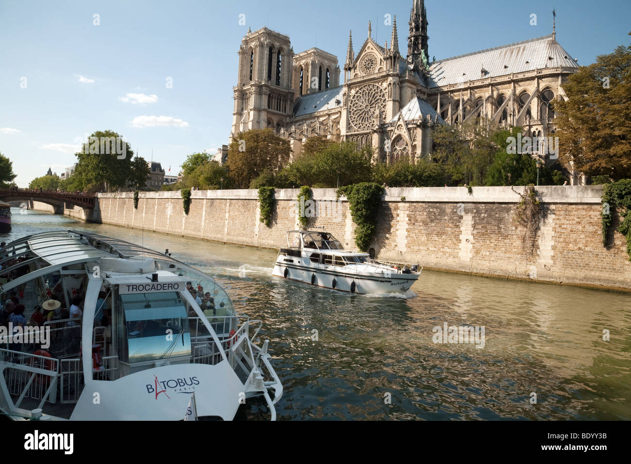 Tourist boats and a Batobus on the River Seine in front of Notre Dame ...