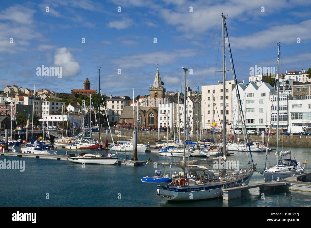 dh Harbours ST PETER PORT GUERNSEY St Peters Port island harbour waterfront yachts and buildings seafront town boats channel islands harbor in marina Stock Photo