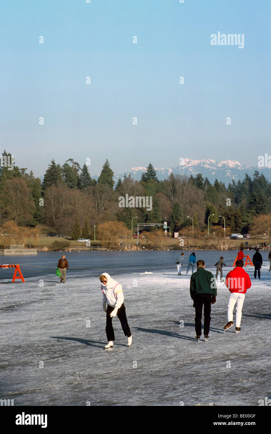 Stanley Park, Vancouver, BC British Columbia, Canada - Skaters ice skating on 'Lost Lagoon', Winter Stock Photo