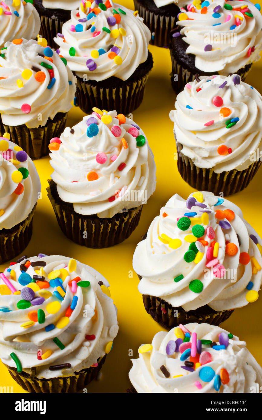 Chocolate cupcakes on yellow background Stock Photo