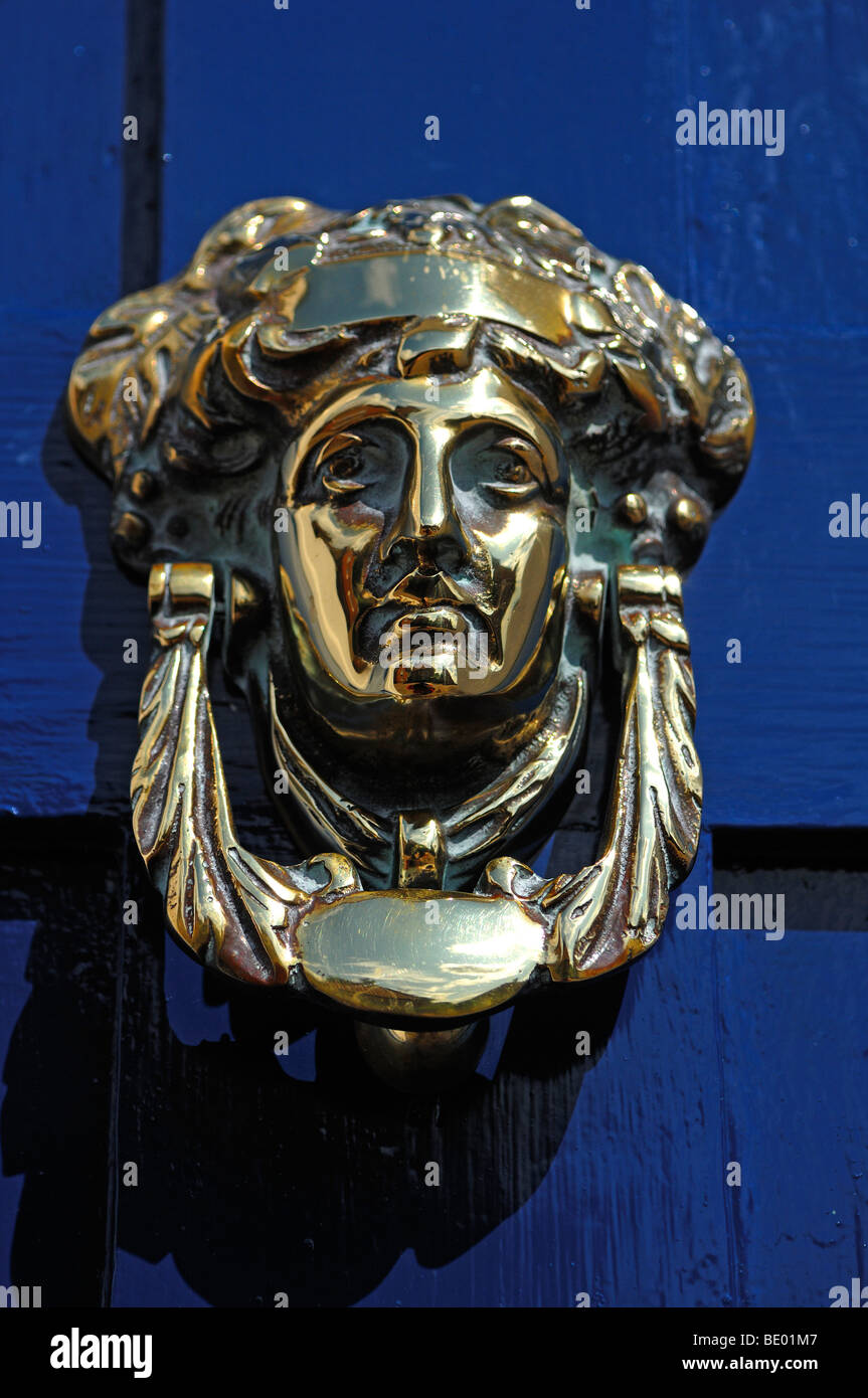 Woman's head as a door knocker made of brass on a blue door, Steep Hill, Lincoln, Lincolnshire, England, UK, Europe Stock Photo