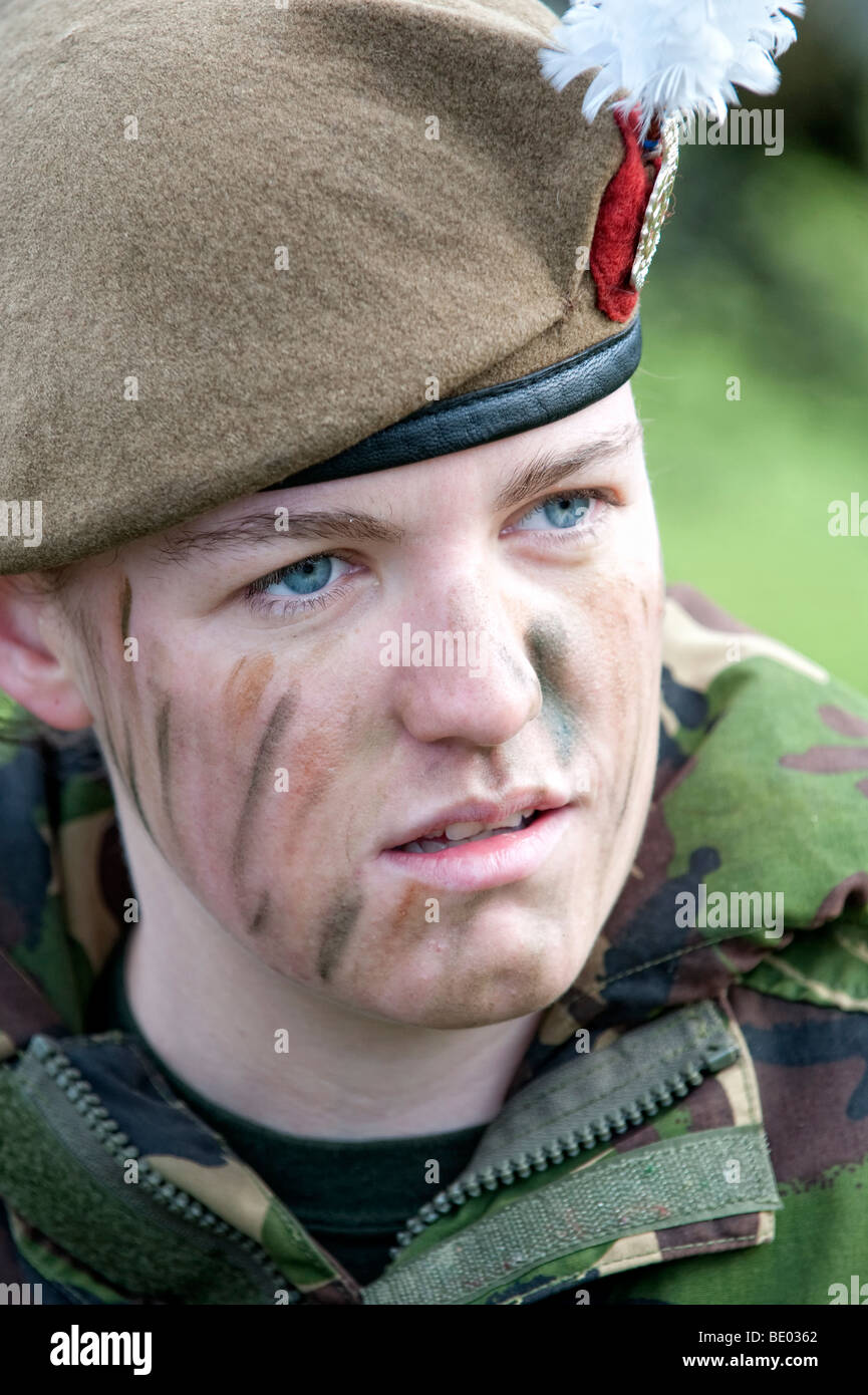 Female soldier in battledress and camouflage makeup Stock Photo
