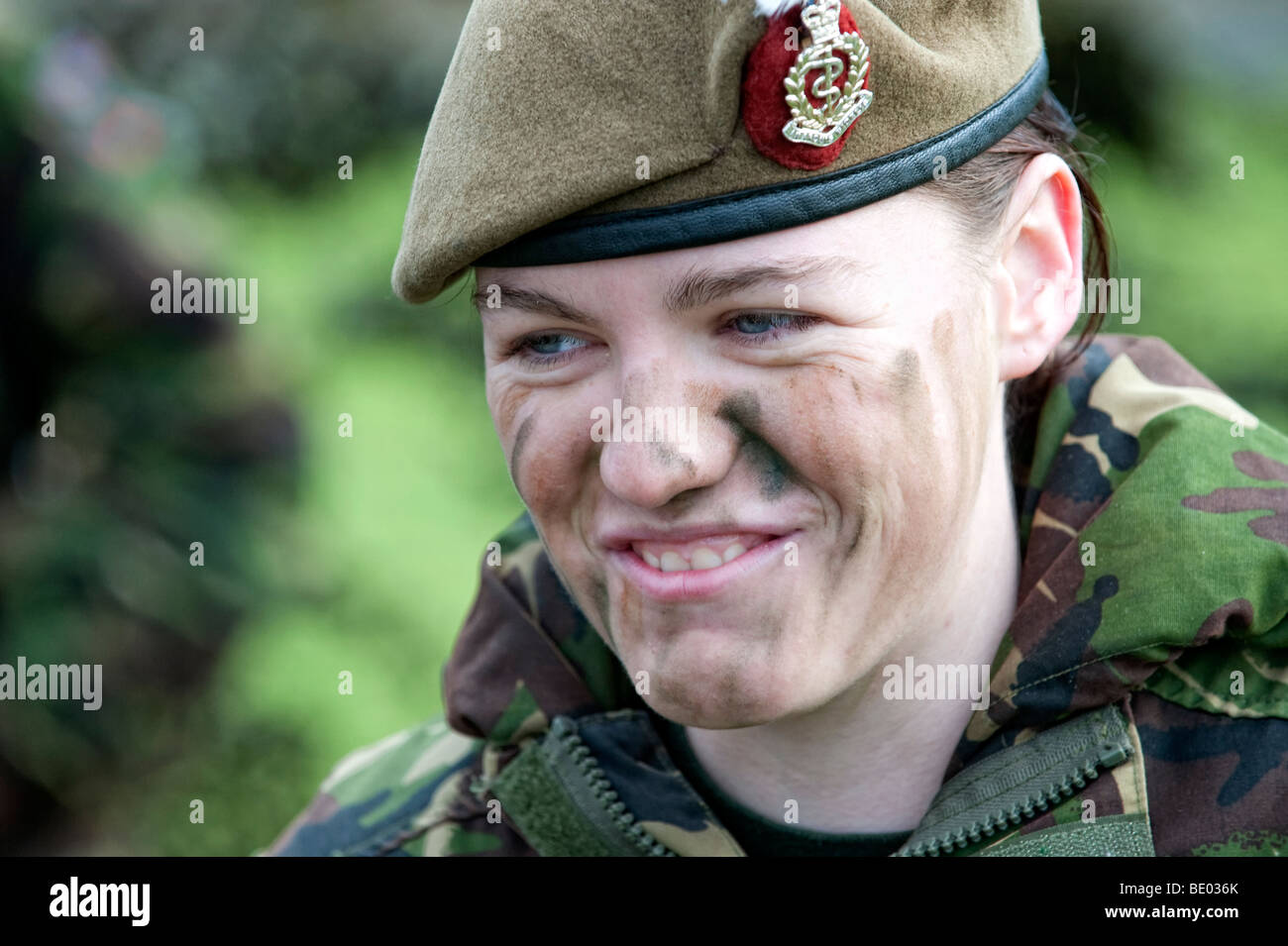 Female soldier in battledress and camouflage makeup Stock Photo