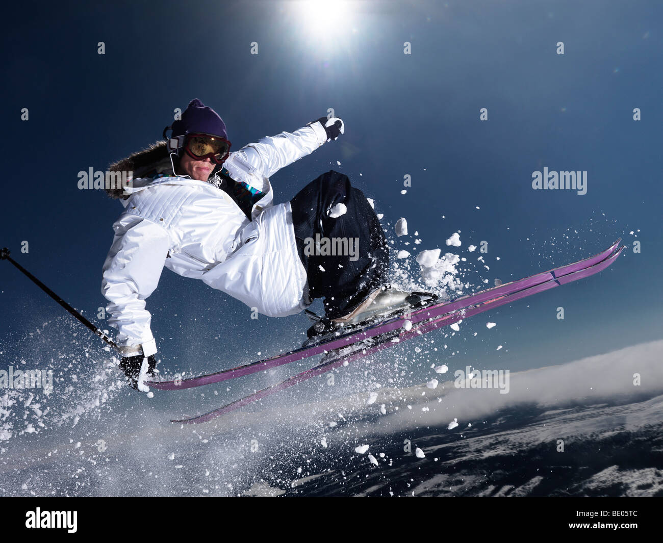 Man grabbing ski tail mid air. Stock Photo