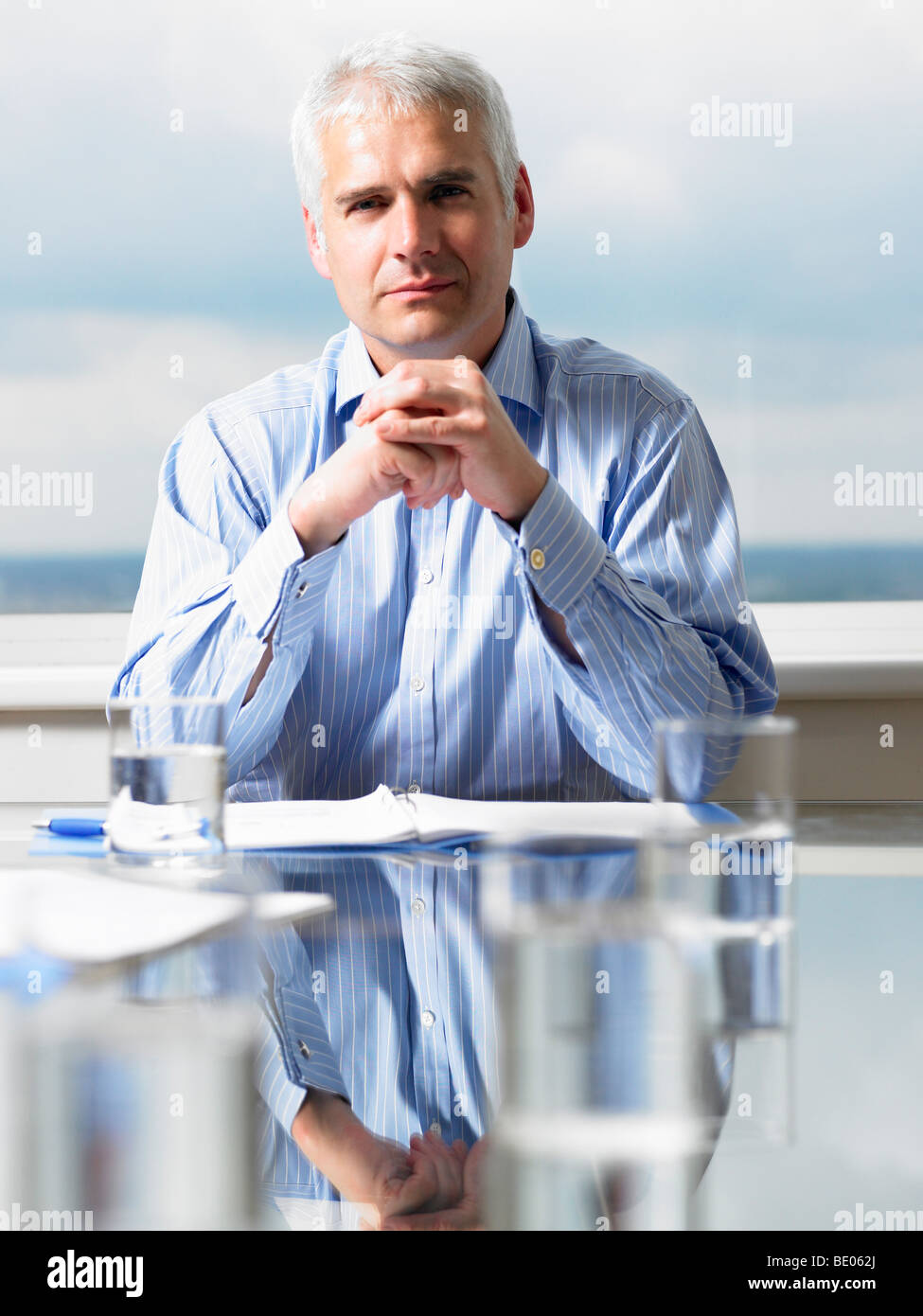 Business man sitting at his desk Stock Photo