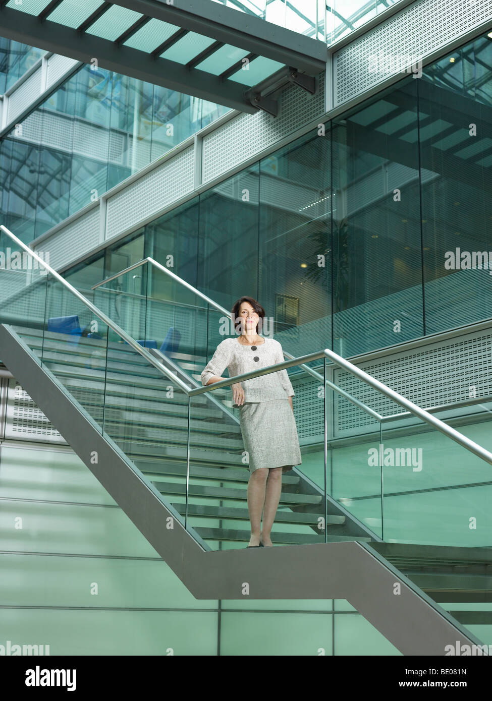 Woman standing on stairs Stock Photo